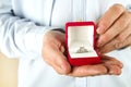 Engagement / marriage / wedding proposal scene. Close up of man handing the expensive gold platinum diamond ring to his bride. Royalty Free Stock Photo