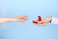 Engagement / marriage / wedding proposal scene. Close up of man handing the expensive gold platinum diamond ring to his bride. Royalty Free Stock Photo