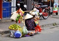 SAIGION, VIETNAM March 06: Woman street vendor selling large green fruit in Vietnam