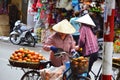 SAIGION, VIETNAM March 06: Woman street vendor selling large orange fruit in Vietnam