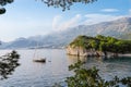 Sail boat in Adriatic sea among mountains in Montenegro, near Sveti Stefan