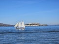 A sail boat crossing in front of Alcatraz Island in San Francisco California Royalty Free Stock Photo