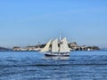 A sail boat crossing in front of Alcatraz Island in San Francisco California Royalty Free Stock Photo