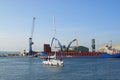 Sail boat motoring into town harbour