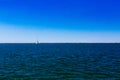 Sail boat over Lake Erie under blue sky, in Cleveland, USA