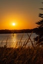 Sail boat shadow with Clear outline of the sun at Sunset with beautiful skyline over lake Zorinsky Omaha Nebraska Royalty Free Stock Photo