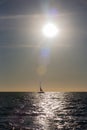Sail boat silhouetted in the setting sun over the ocean in Mexico Royalty Free Stock Photo