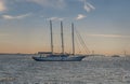 Sail boat traveling in New York's Hudson Bay in front of a bridge during the golden hour of sunet