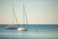 Sail boats anchored on a calm sea in late afternoon Royalty Free Stock Photo