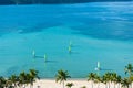 Sail boats / catamarans with colorful sails, kayaks and paddle boarders, on the blue water off the beach in front of Hamilton Royalty Free Stock Photo