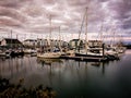 the sail boats are docked near the resort at dusk, Royalty Free Stock Photo