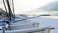 Sail boats on a pebble beach on a frozen snowy frosty morning