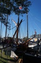 Sail boats stands moored near the river promenade of Muiden