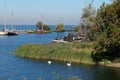 Sail boats stands moored near the river promenade of Muiden