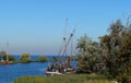 Sail boats stands moored near the river promenade of Muiden