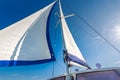 Sail of a sailing boat against sky with sun rays Royalty Free Stock Photo