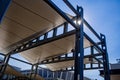 Sail shade pergola made of galvanized steel and white canvas tall standing strong structure against the blue sky