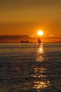 Sail and ship at sunset on Pacific ocean Royalty Free Stock Photo