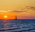 Sail yacht crossing sea at the sunset