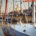 Sail yacht standing moored in the sea port, sailboat harbor. Forward, sail and nautical ropes yacht details. Modern water Royalty Free Stock Photo