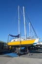 Sail yachts beached at a dock for painting, repair and maintenance