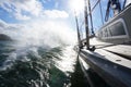 Sailboat in action with water moving next to the boat, forward speed with wind. Royalty Free Stock Photo