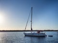 Sailboat anchored on a beach in the Formentera island during sunset. Royalty Free Stock Photo