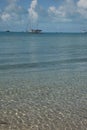 Sailboat anchored off of clear, tropical Beach Royalty Free Stock Photo