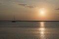 Sailboat anchored in open sea during sunset. Romantic sailing boat yacht sundown photo. Royalty Free Stock Photo