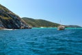 ARRAIAL DO CABO, RIO DE JANEIRO, BRAZIL- MARCH 21, 2016: Sailboat and a boat over a green and clear waters near a coast.