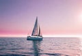 Sailboat in a calm sea during a bright sunset with pink clouds, vacation on a yacht in the ocean Royalty Free Stock Photo