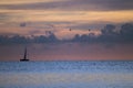 Sailboat, clouds and calm blue sea