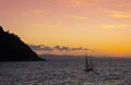 Sailboat on the coast of the city of Donostia with the last rays of the sun at sunset, Cantabrico Sea.