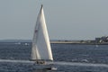Sailboat crossing New Bedford outer harbor