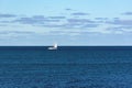 A sailboat cruises on boundless seas Royalty Free Stock Photo