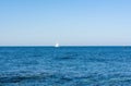 A sailboat cruises on boundless seas Royalty Free Stock Photo