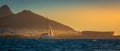 Sailboat cruises Cape Town with Table Top Mountain and Lions Head at sunset