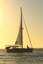 Sailboat cruising away from Sunset on the west coast of florida Royalty Free Stock Photo