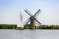 A sailboat and a Dutch windmill on the Kaag Royalty Free Stock Photo