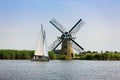 a sailboat and a Dutch windmill Royalty Free Stock Photo