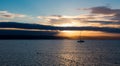 Sailboat with fallen sails in sunrise light on full sea Royalty Free Stock Photo