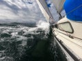 Sailboat against storm and waves in open sea. Concept of travel, adventure and vacation. Royalty Free Stock Photo