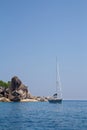 Sailboat and giant rock Royalty Free Stock Photo