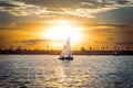 Sailboat gliding past the sun in San Diego, California, USA