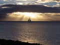 Sailboat gliding at sunset