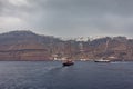 Sailboat heading towards the port of Fira village, Santorini Island