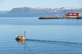 A sailboat leaving harbor in Northern Norway