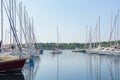 Sailboat leaving harbor, Yachts and boats parked in harbor, sunrise, morning Royalty Free Stock Photo