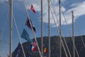 Sailboat mast with flags	near the mountain in port Royalty Free Stock Photo