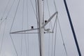 Sailboat mast with rope in port and clouds Royalty Free Stock Photo